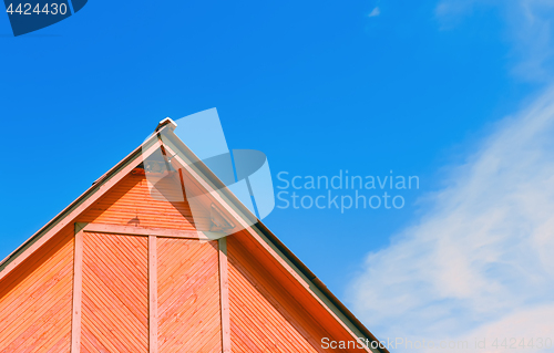 Image of Top Of A Rustic Wooden Building Against The Sky