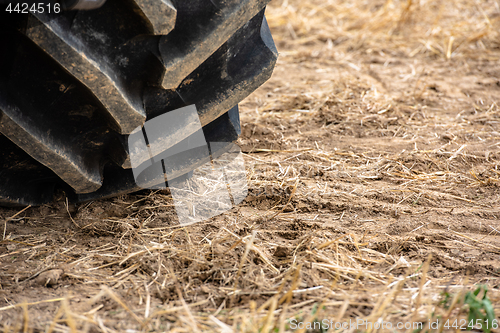 Image of Wheels of tractor plowing field