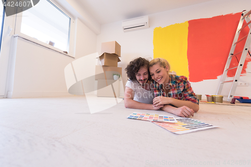 Image of Happy young couple relaxing after painting