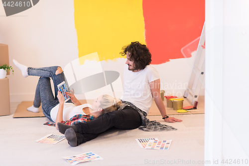 Image of Happy young couple relaxing after painting