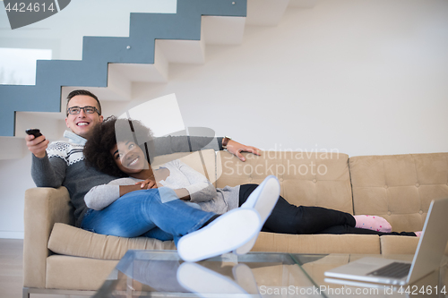 Image of multiethnic couple relaxing at home