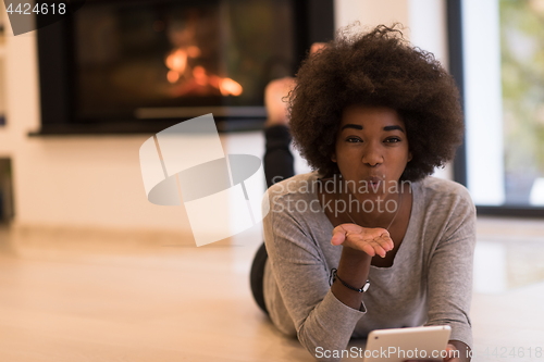 Image of black women using tablet computer on the floor