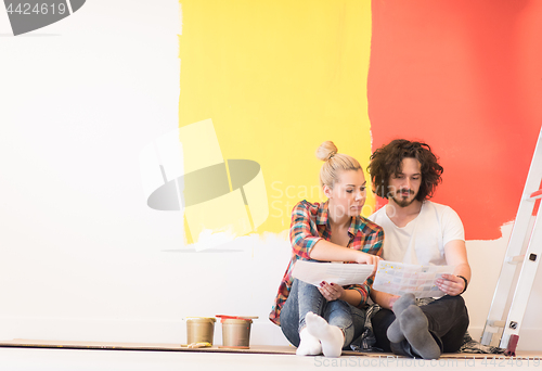 Image of Happy young couple relaxing after painting