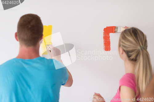 Image of couple painting interior wall