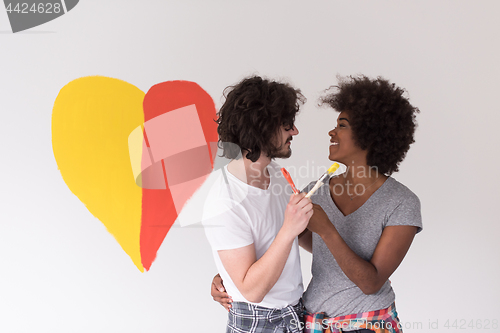 Image of couple with painted heart on wall