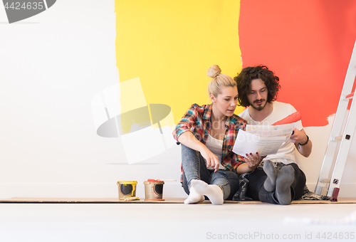 Image of Happy young couple relaxing after painting