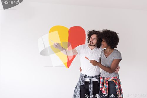 Image of couple with painted heart on wall