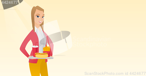 Image of Woman holding tray full of fast food.