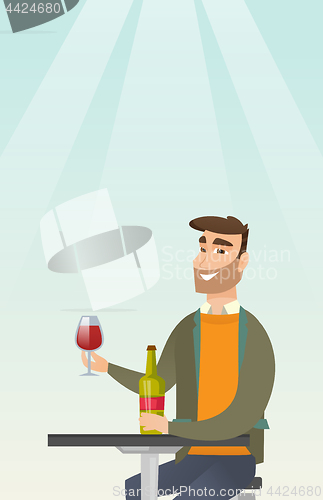 Image of Man drinking wine in the restaurant.