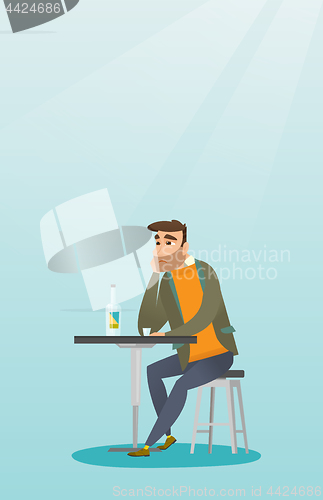 Image of Man drinking a cocktail in the bar.