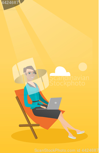 Image of Businesswoman working on laptop at the beach.