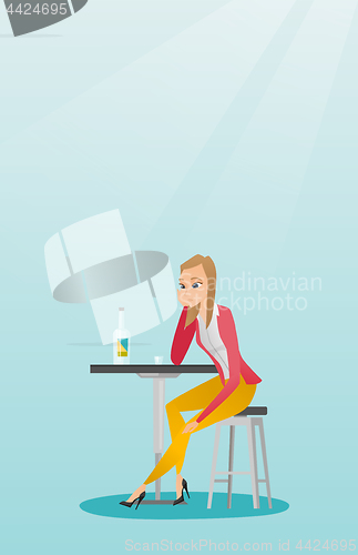 Image of Woman drinking a cocktail in the bar.