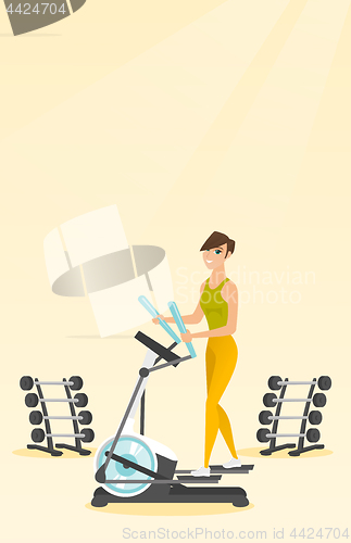Image of Woman exercising on elliptical trainer.