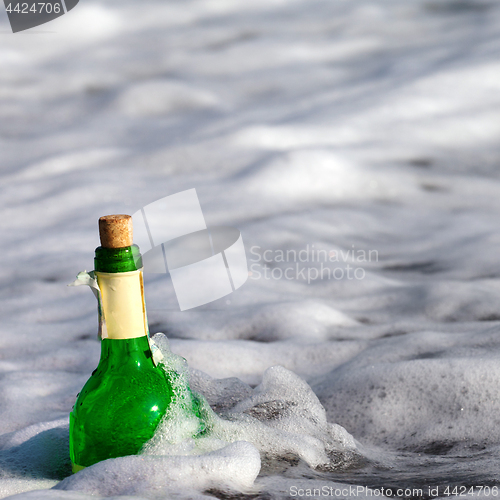 Image of Bottle of wine in sea surf