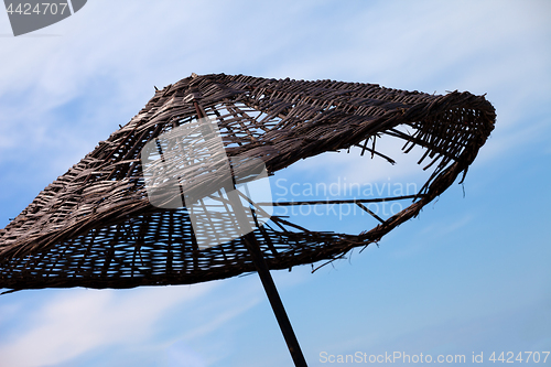 Image of Old sunshade with hole and blue sky