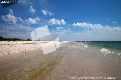 Image of Clear sea with sand beach and blue sky with clouds