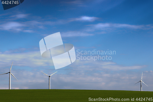Image of windmills for green energy in the field