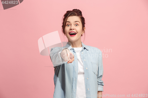 Image of The happy business woman point you and want you, half length closeup portrait on pink background.