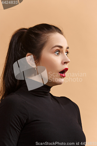 Image of Beautiful woman looking suprised isolated over pastel studio