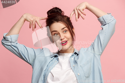 Image of The squint eyed woman with weird expression isolated on pink