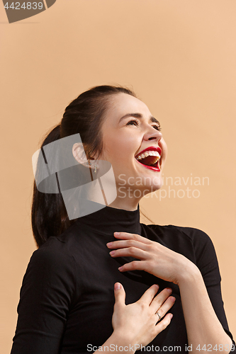 Image of The happy business woman standing and smiling against pastel background.