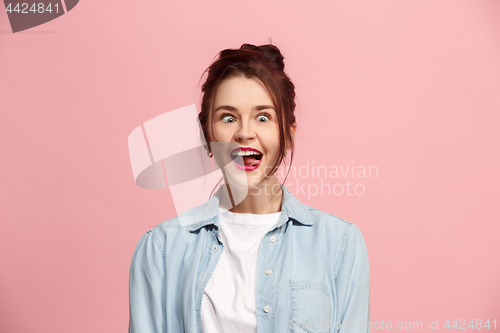 Image of The squint eyed woman with weird expression isolated on pink