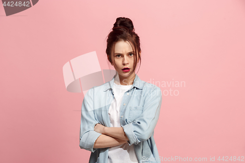 Image of Suspiciont. Doubtful pensive woman with thoughtful expression making choice against pink background