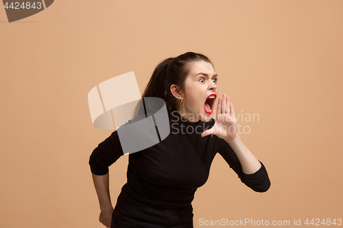 Image of The young emotional angry woman screaming on pastel studio background