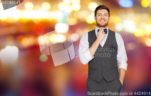 Image of man in festive suit over night city lights