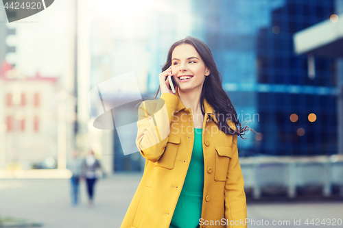 Image of smiling young woman or girl calling on smartphone