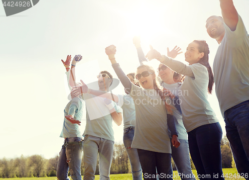 Image of group of volunteers celebrating success in park