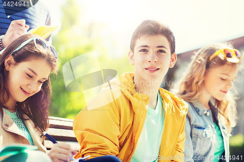 Image of group of students with notebooks at school yard