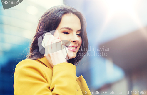 Image of smiling young woman or girl calling on smartphone