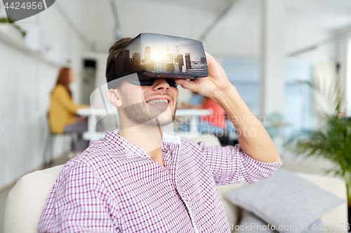Image of happy man with virtual reality headset at office