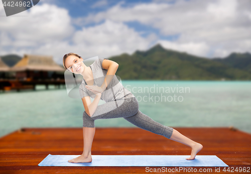 Image of woman making yoga low angle lunge pose outdoors