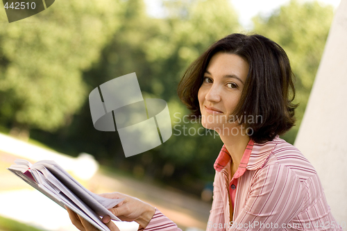 Image of woman reading in park