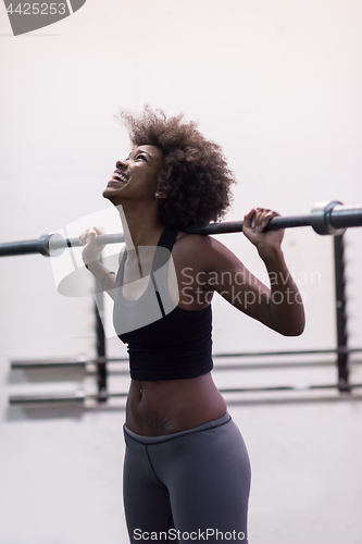 Image of black woman lifting empty bar