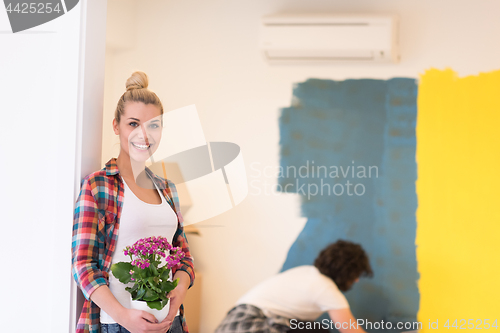 Image of happy young couple doing home renovations