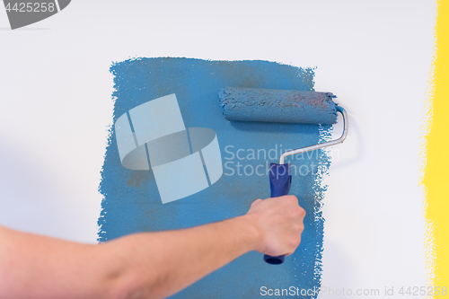 Image of Decorator\'s hand painting wall
