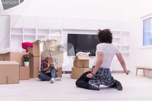 Image of young couple moving  in new house