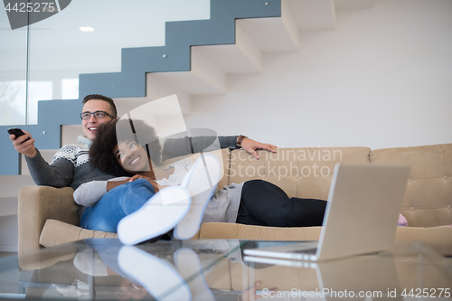 Image of multiethnic couple relaxing at home