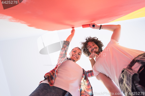 Image of couple painting interior wall