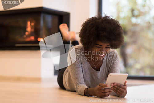 Image of black women using tablet computer on the floor