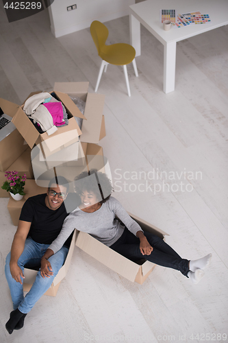 Image of African American couple  playing with packing material