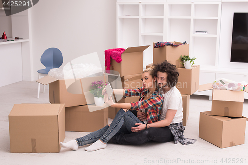 Image of young couple moving  in new house