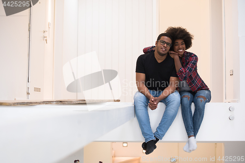 Image of couple having break during moving to new house