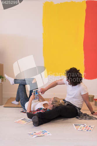 Image of Happy young couple relaxing after painting