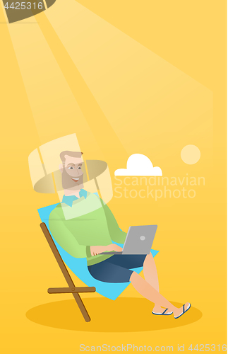 Image of Businessman working on laptop on the beach.