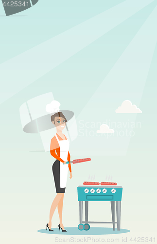 Image of Woman cooking steak on barbecue grill.