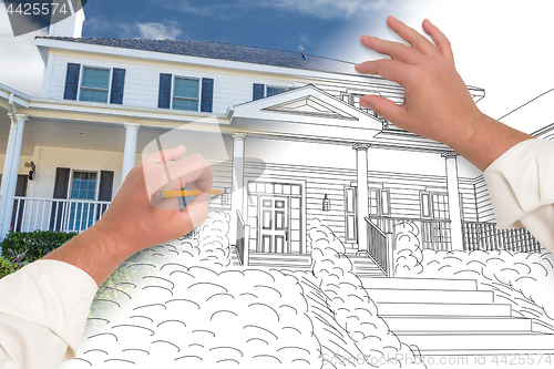 Image of Male Hands Sketching with Pencil the Outline of a House with Pho